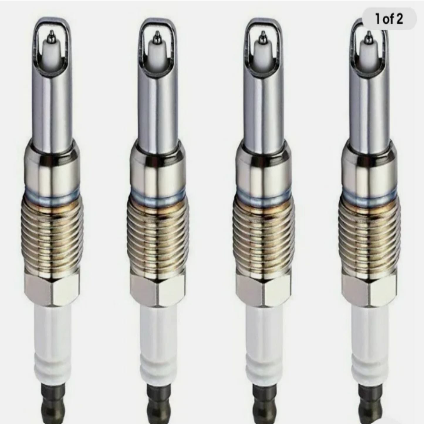 Four spark plugs arranged in a row on a white background