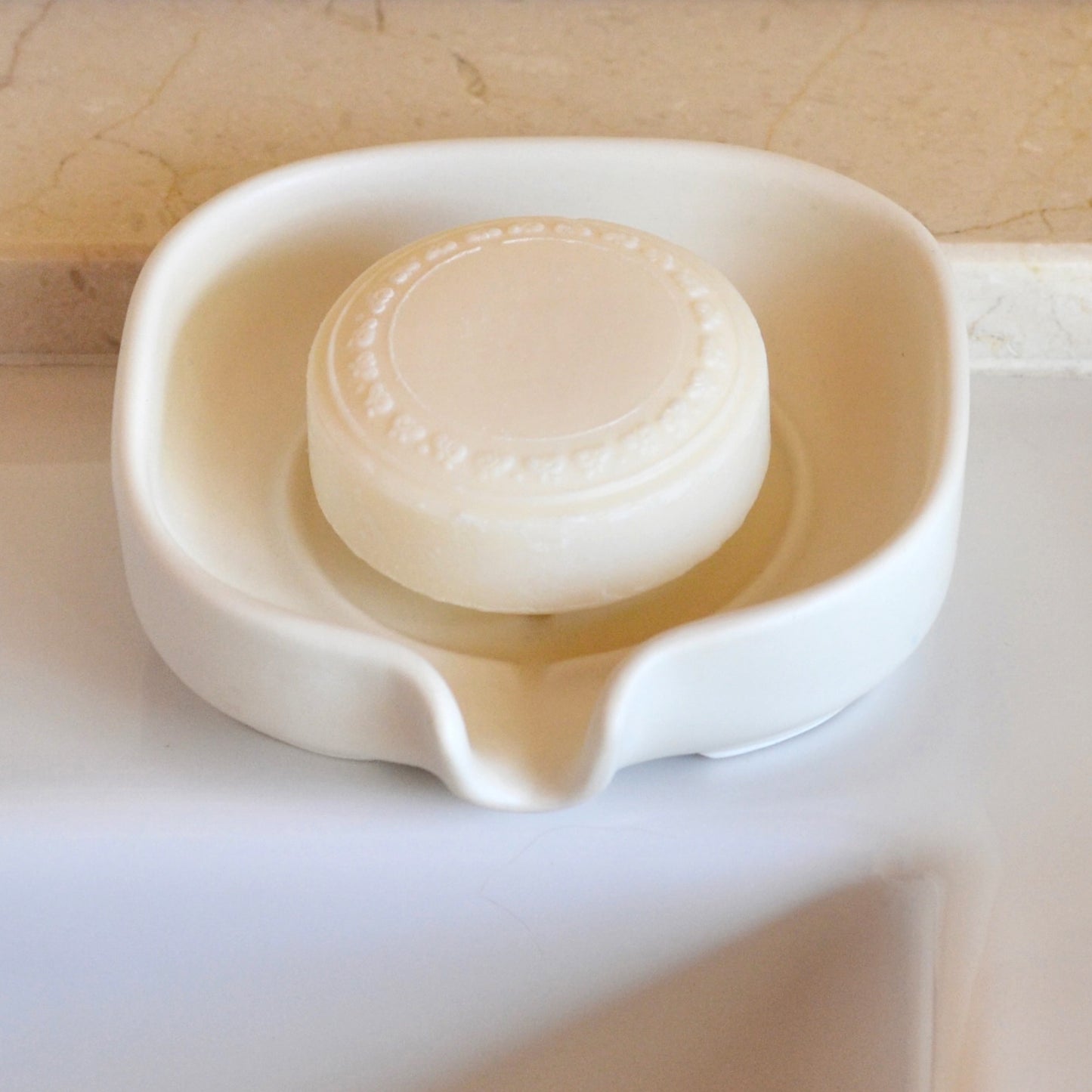 Elegant soft white color self-draining porcelain soap dish with a sloped design to keep soap dry and clean. Soap not included.