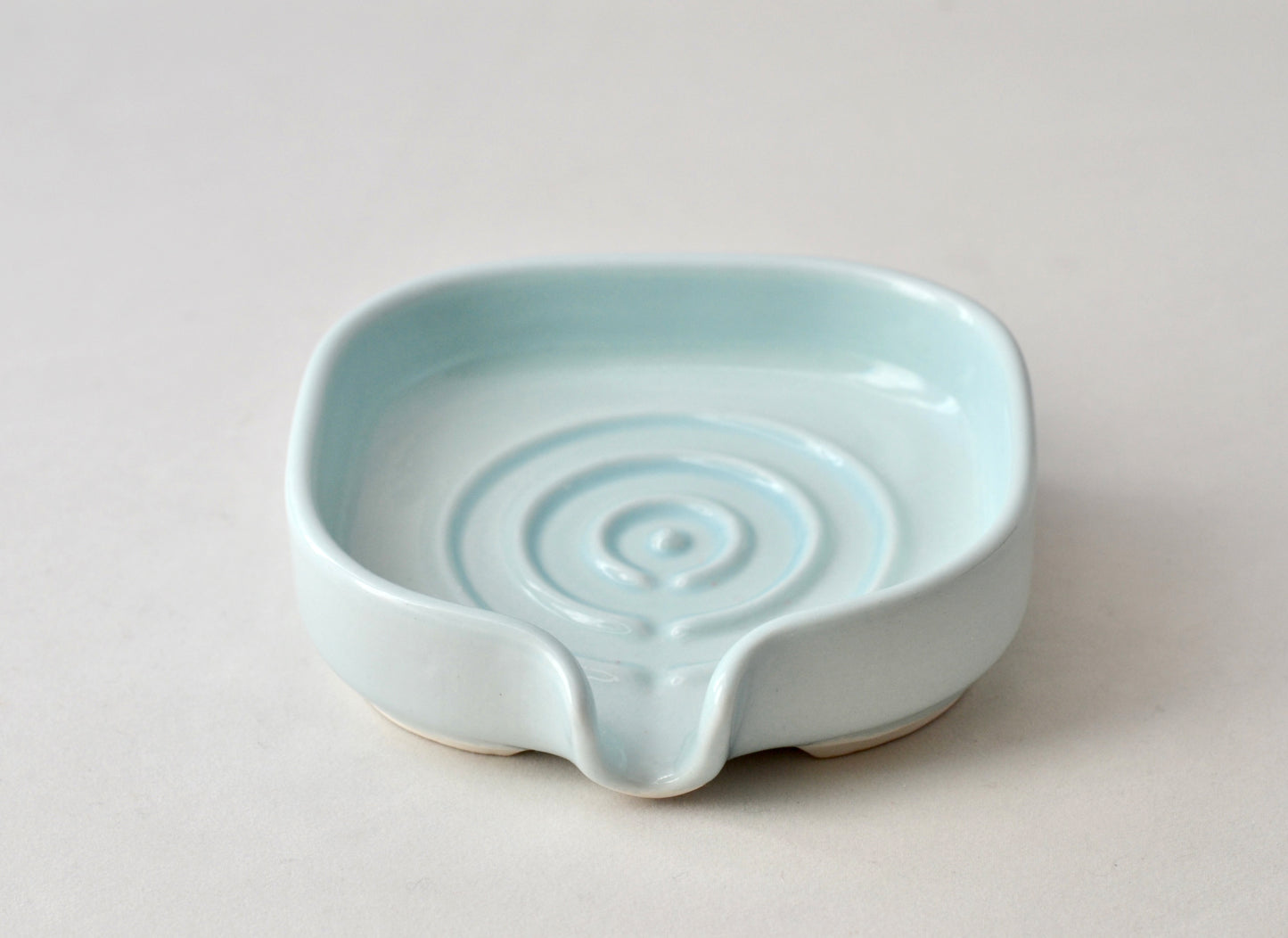 Elegant soft celery color self-draining porcelain soap dish with a sloped design to keep soap dry and clean. Pattern shown. Soap not include