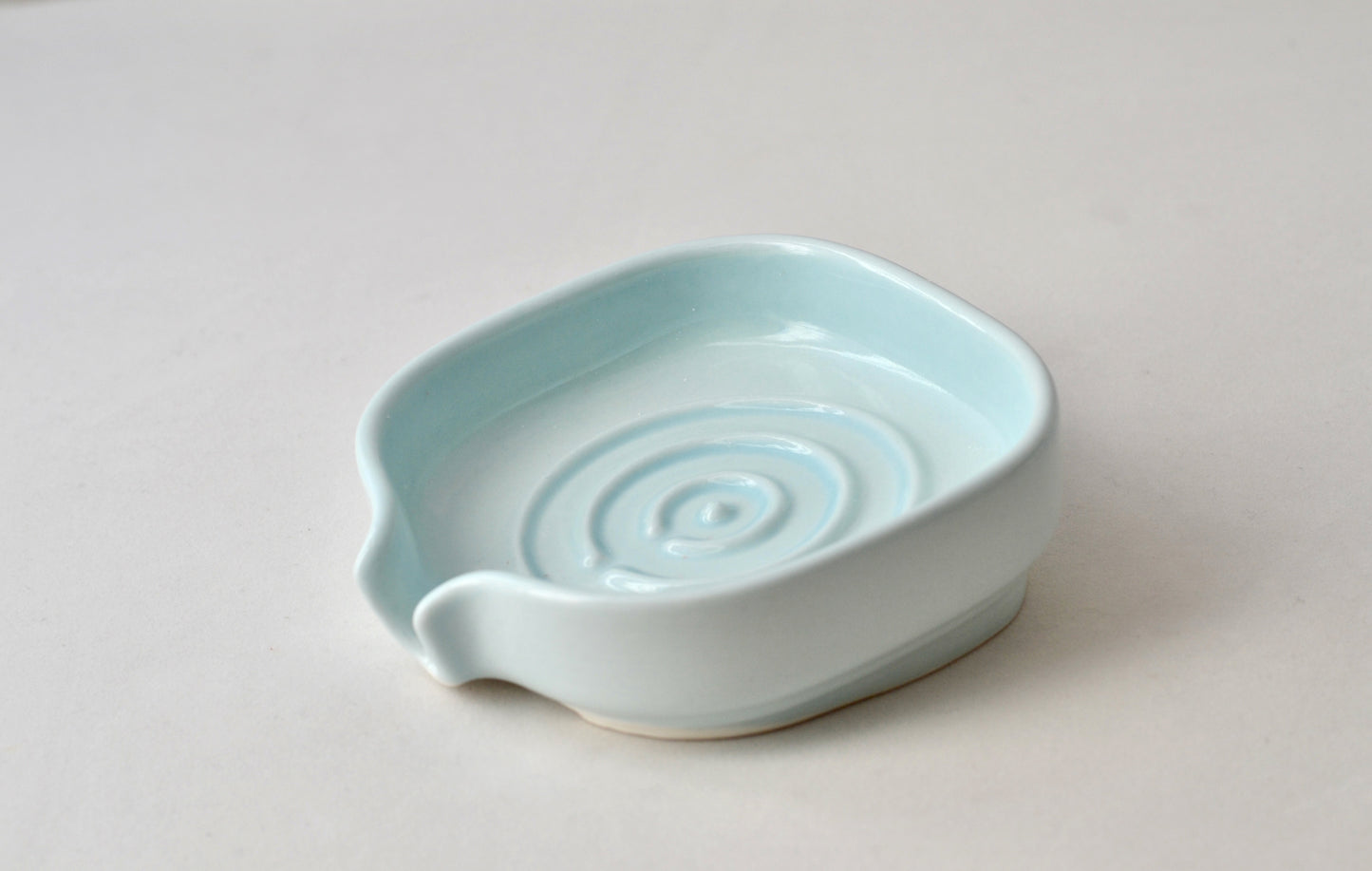 Elegant soft celery color self-draining porcelain soap dish with a sloped design to keep soap dry and clean. Pattern shown. Soap not include