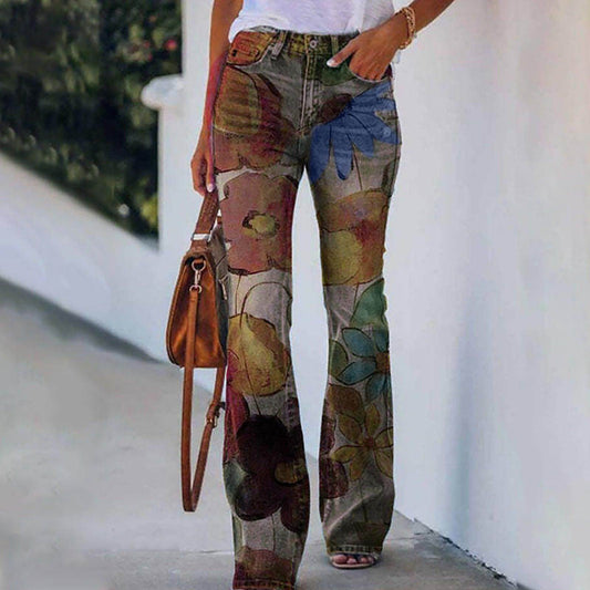 Person wearing floral-patterned pants with a white wall and greenery in the background