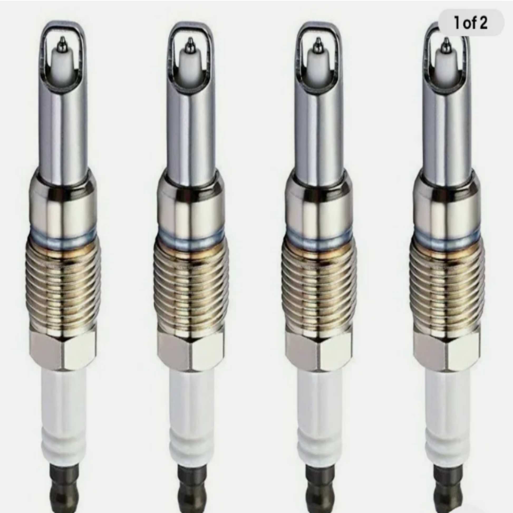 Four spark plugs arranged in a row on a white background