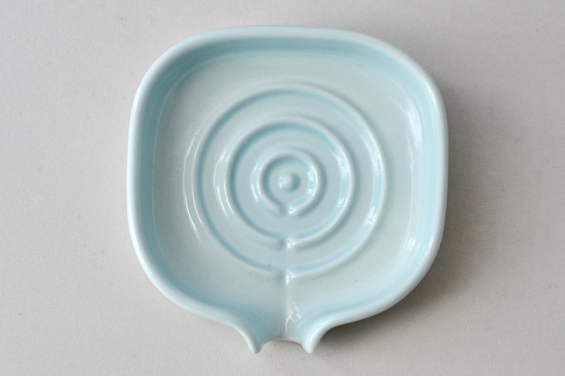 Elegant soft celery color self-draining porcelain soap dish with a sloped design to keep soap dry and clean. Pattern shown. Soap not include