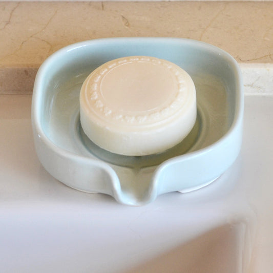 Elegant soft celery color self-draining porcelain soap dish with a sloped design to keep soap dry and clean. Soap not included.