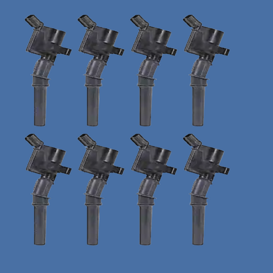 Set of eight black ignition coils on a white background